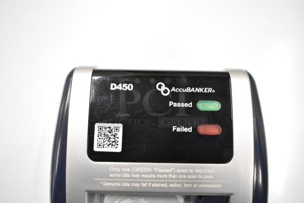 AccuBanker D450 counterfeit bill detector with "Passed" and "Failed" indicators, visible QR code, and instructional text.