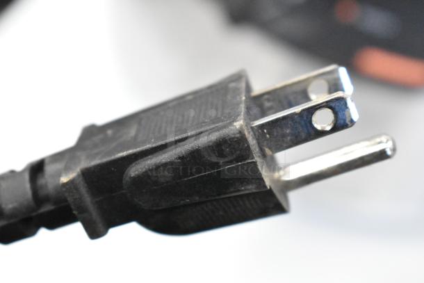 Close-up of a three-prong plug for a 2022 Nemco 6100A Stainless Steel Commercial Soup Kettle Food Warmer, 120V, 1 Phase.