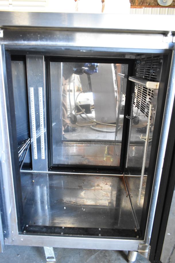 Perlick PTS60-RO-1 stainless steel 2-door back bar cooler in used condition. 115 volts, 1 phase. Interior shelves visible.