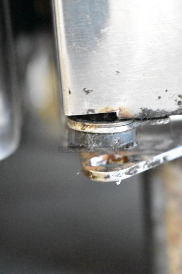 Close-up of Perlick PTS60-RO-1 stainless steel cooler corner. Shows signs of wear and rust on the metal surface.