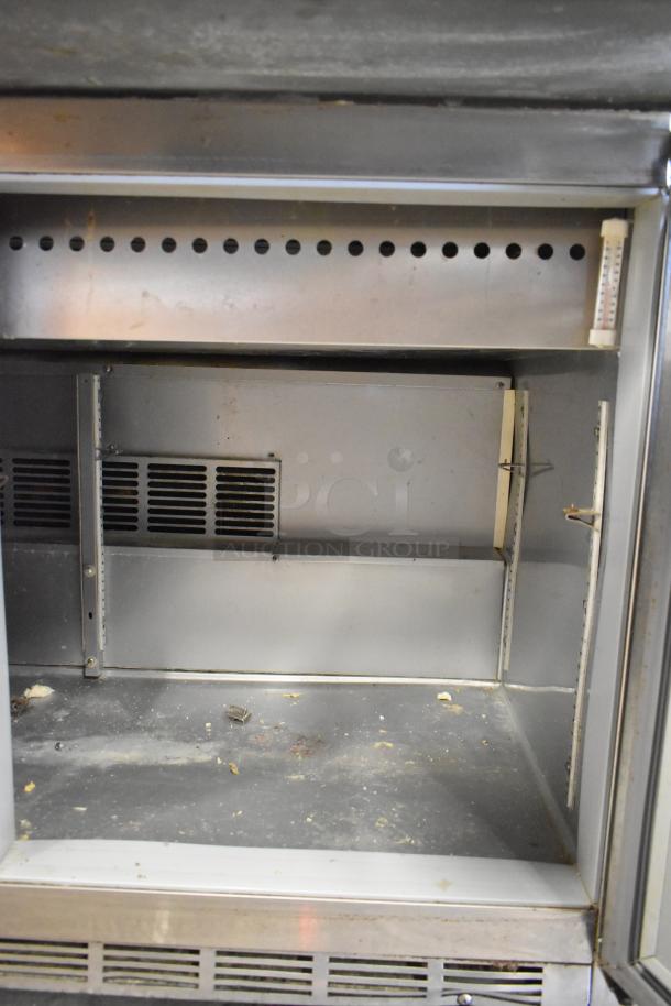 Beverage Air SPE48-18M-HMP stainless steel prep table with bain marie top, visible interior wear, on commercial casters.