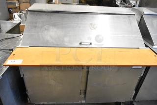 Beverage Air stainless steel commercial prep table in used condition, features bain marie mega top, on commercial casters.