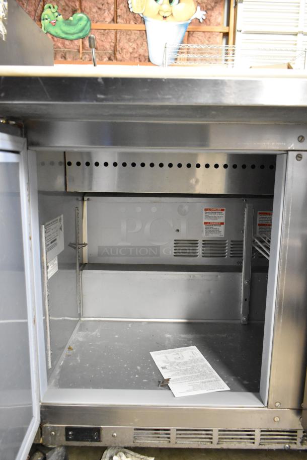Beverage Air SPE48HC-12C stainless steel sandwich prep table, open door showing interior, commercial casters, 115V.