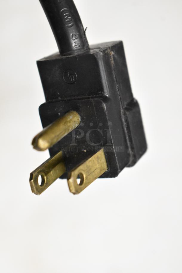 Close-up of a three-prong electrical plug for Beverage Air SPE48HC-12C sandwich prep table, 115 volts, 1 phase.