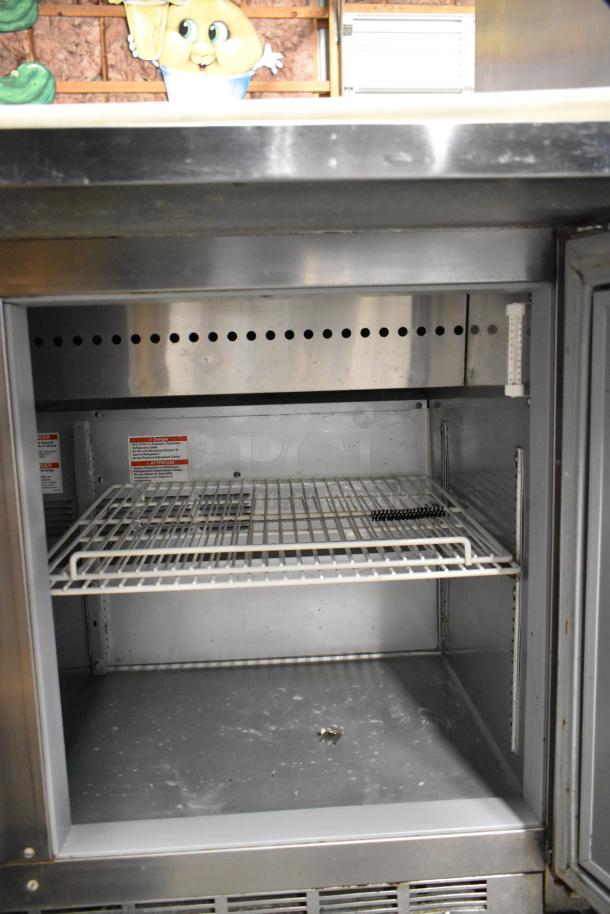 Beverage Air SPE48HC-12C stainless steel prep table, interior view, shelves, commercial casters, 115V, 1 phase.