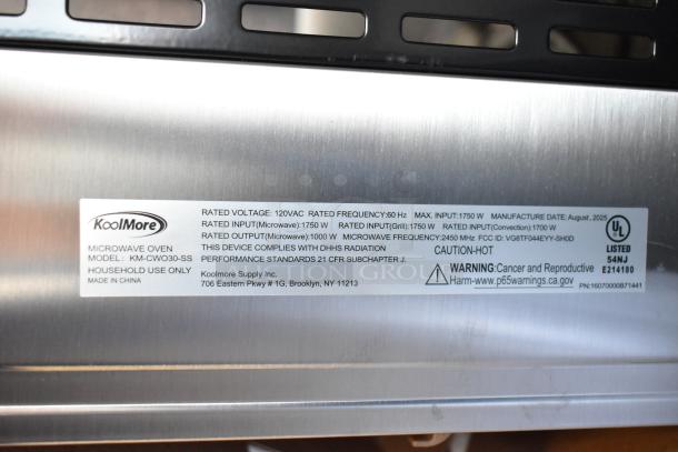 BRAND NEW KoolMore KM-CWO30-SS stainless steel microwave with convection and air fryer. 120V, 1 Phase. Label shows specs and warnings.