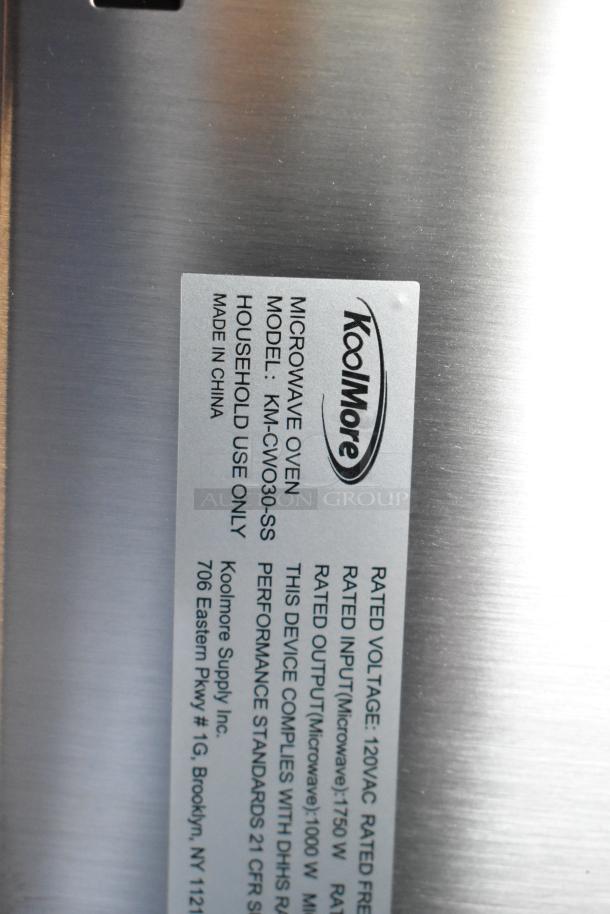 KoolMore KM-CWO30-SS stainless steel microwave with convection oven and air fryer, new with scratch and dent. Model label visible.