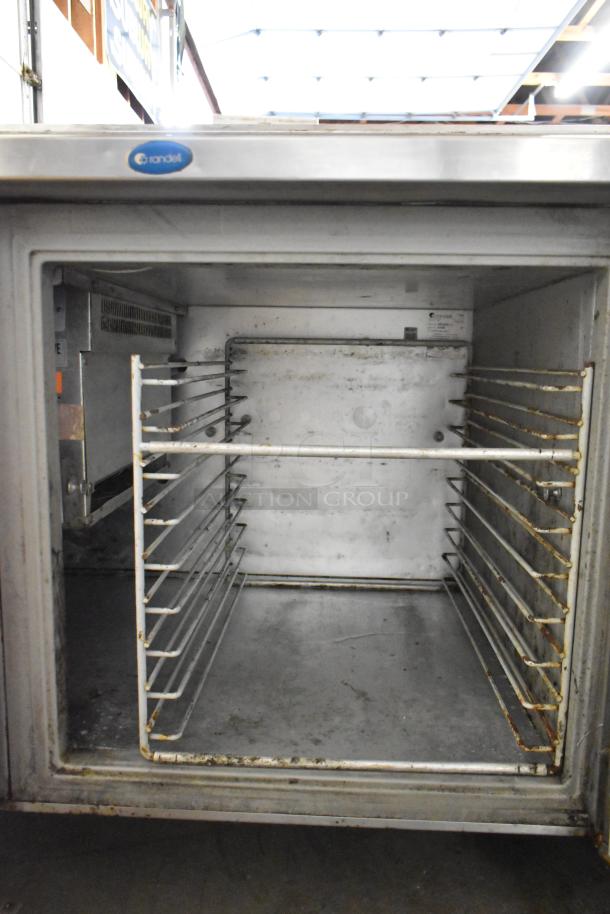 Randell stainless steel commercial pizza prep table, interior view, metal racks, on commercial casters, 115V, 1 phase.