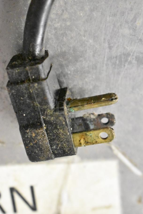 Randell stainless steel pizza prep table plug, showing signs of wear and corrosion, 115 volts, 1 phase.