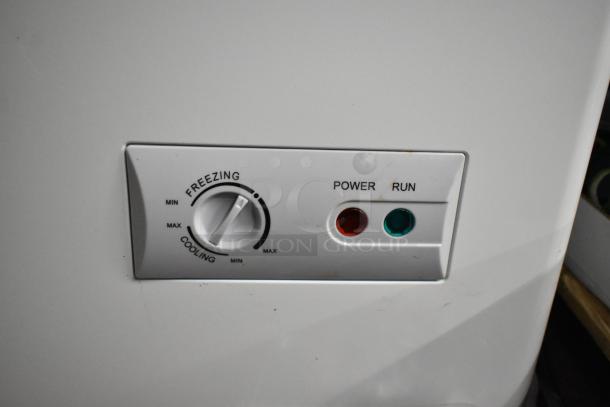KoolMore SCF-24C metal commercial chest freezer control panel; features freezing/cooling dial, power, and run indicators.
