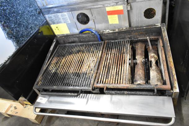 MagiKitch'n stainless steel commercial countertop gas charbroiler grill, showing wear. Features dual grates and visible labels.