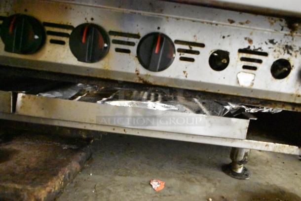 MagiKitch'n Stainless Steel Charbroiler Grill, gas-powered, countertop model, with control knobs, in used condition.