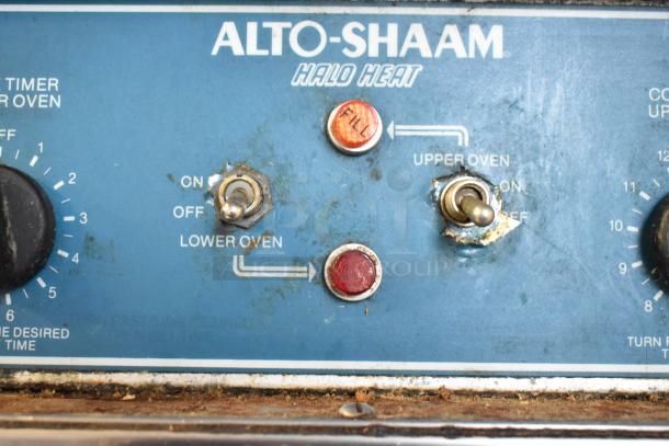 Alto Shaam 1000-TH Halo Heat Oven control panel, featuring knobs and switches, shows signs of wear.