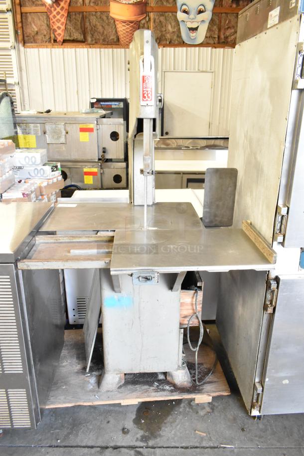 Biro Model 33 metal commercial floor-style meat saw in used condition. Features sturdy metal construction with visible wear.