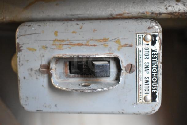 Biro 33 metal commercial meat saw with visible wear. Features a Westinghouse motor snap switch. Made in USA.