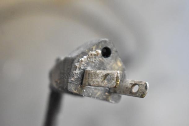 A close-up of a worn electrical plug for the Biro 33 Metal Commercial Floor Style Meat Saw.