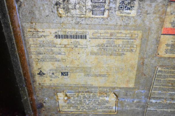 Pitco Frialator SG14 fryer label with specs: 110,000 BTU, natural gas, NSF certified, 40 lbs capacity. Rust visible.