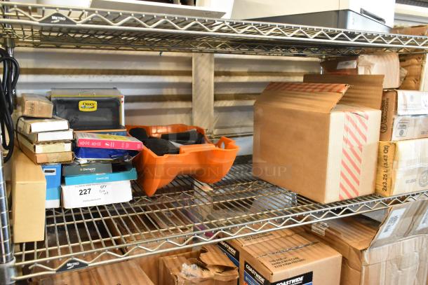 Tiered shelf with individually bagged tongs, Diversey Stride Citrus Neutral Cleaner, cables, phone cases in various conditions.