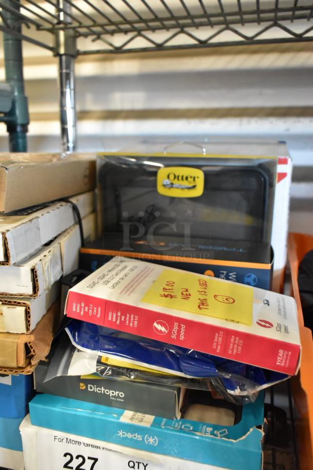 Auction lot with individually bagged tongs, Diversey Stride Citrus Neutral Cleaner, cords, phone cases, Otter box visible.