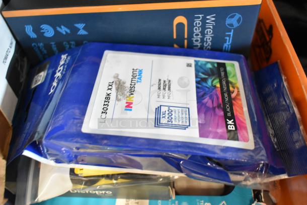 Auction lot including Brother LC3033BK XXL ink, wireless headphones, cords, and Diversey Stride Citrus Cleaner. Items vary in condition.