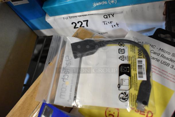 Tiered lot of assorted items, including bagged tongs, Diversey Stride Citrus Cleaner, cords, and phone cases.