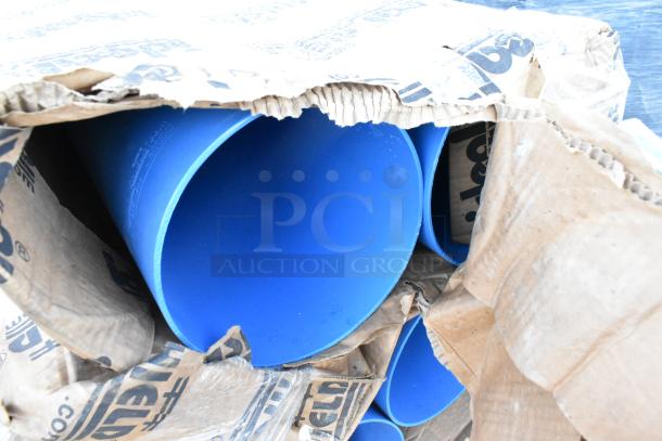 Blue poly tubes partially exposed in a torn cardboard box, part of a lot with patio umbrellas; items in used condition.