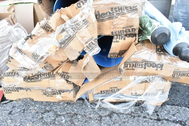 Various items including patio umbrellas and blue poly tubes, wrapped in Ideal Shield branded packaging. Condition appears used.