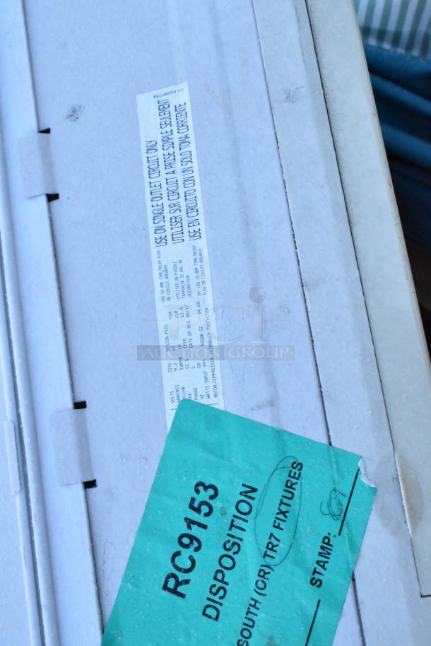 Alt text: Air conditioner unit with label "Use on single outlet circuit" and disposition tag "RC9153."