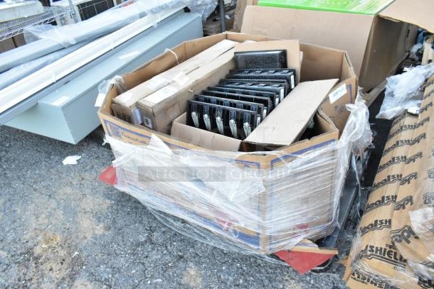 17 various items in a large cardboard box, including multiple cash drawer inserts, wrapped in plastic, on a pallet.