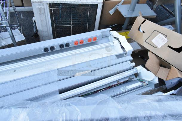 18 items including assorted light fixtures and a gray metal unit, mixed condition. Includes visible cables and surface details.