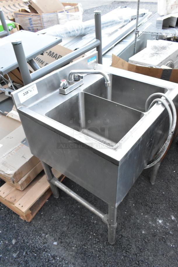 Stainless steel 2 bay sink with faucet and handles, lightly used, industrial style with visible label and sturdy legs.