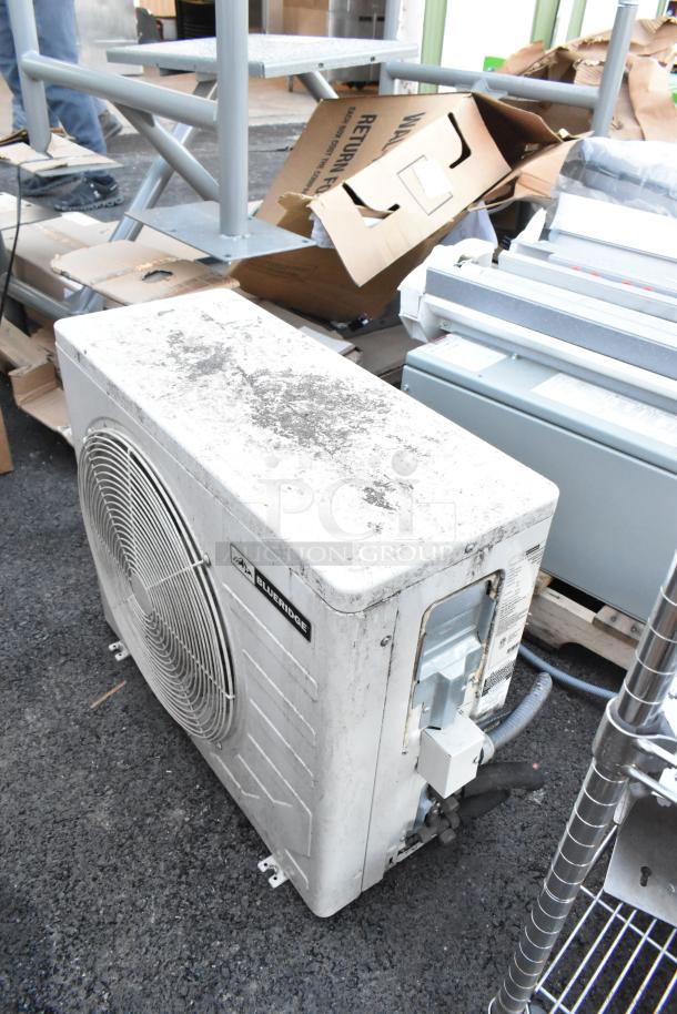 Blueridge BMKH09-D3DNC9K/O 9,000 BTU outdoor AC unit, metal exterior, used, 208/230V, 1 Phase, visible brand label.