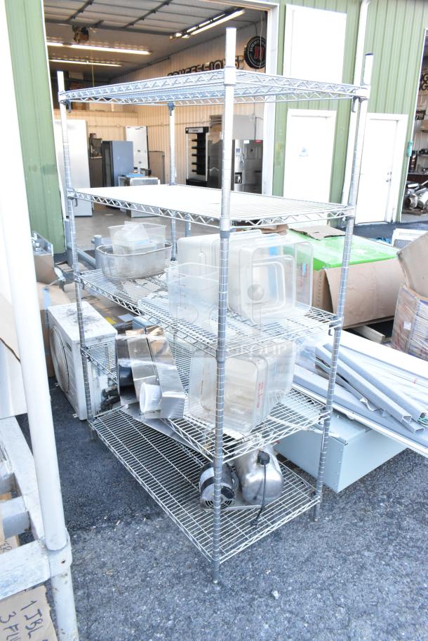 Chrome finish 5-tier wire shelving unit with poly bins and various contents. Buyer must dismantle; freight charges apply.