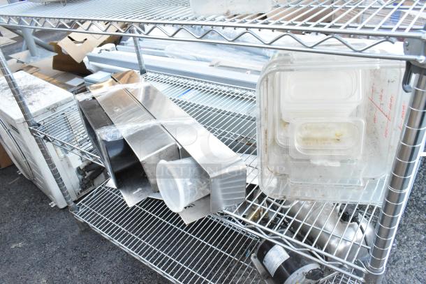 Chrome finish 5-tier wire shelving unit with contents including poly bins. Buyer must dismantle. Freight charges apply.