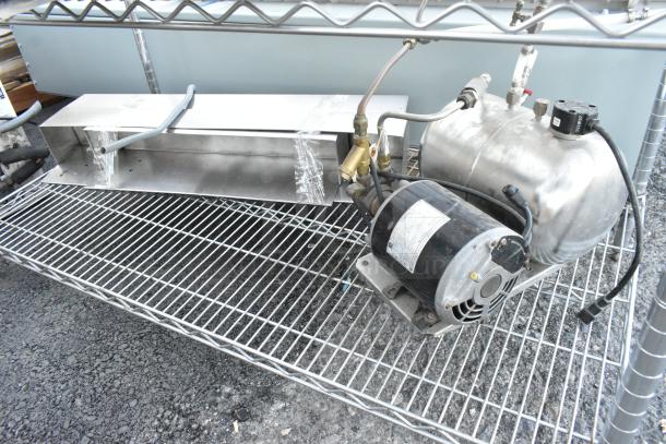 Chrome finish 5-tier wire shelving unit with attached motor and metal component; includes poly bins, needs dismantling.