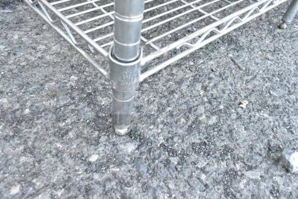 Chrome finish 5 tier wire shelving unit corner detail, includes poly bins. Buyer must dismantle. Consider freight charges.