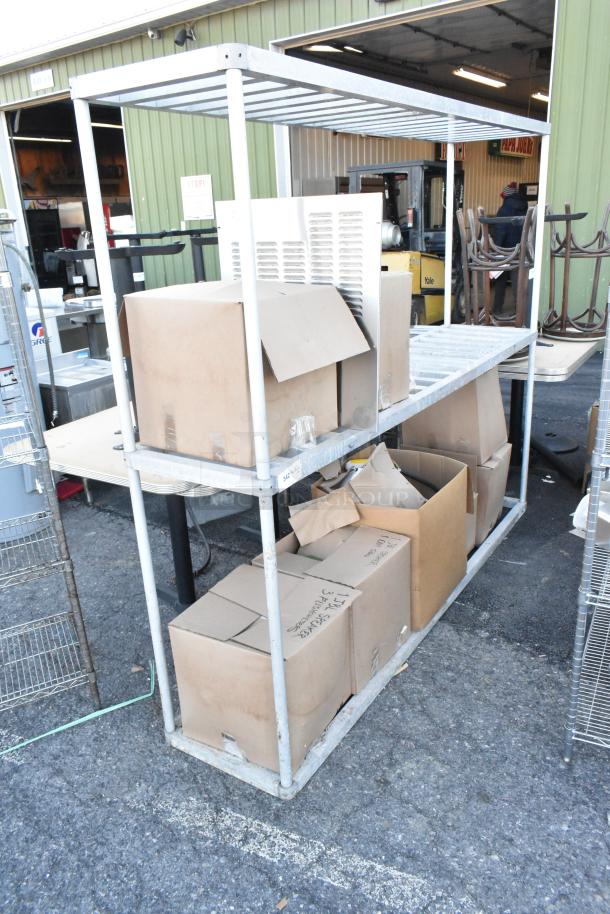 Metal 3-tier dunnage shelving unit with boxes containing lights and a speaker. Buyer must dismantle. Consider freight charges.
