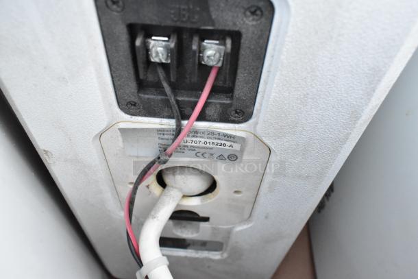 Back of speaker with wiring and label showing model "Control 28-1-WH," impedance 8 ohms, and serial number.