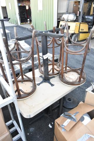 5-piece set with 2 tables, 3 stools upside down on a table. Wooden frames, metal legs. Visible tag: "343". Used condition.
