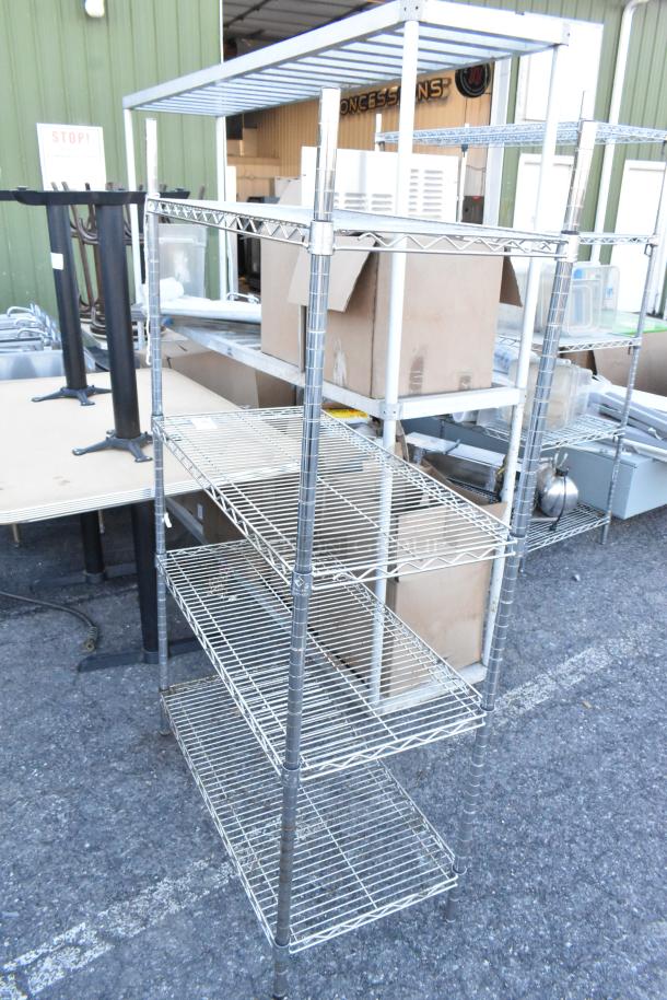 Chrome finish 4-tier wire shelving unit in outdoor setting, good condition. Buyer must dismantle for shipping.