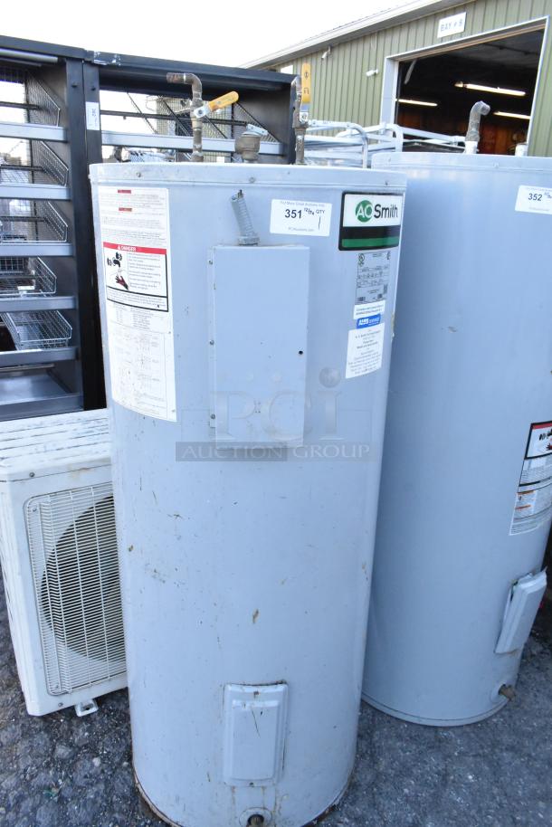 AO Smith DEN-80 110 metal commercial water heater, 208 volts, 1/3 phase. Visible labels indicate model and operating instructions.