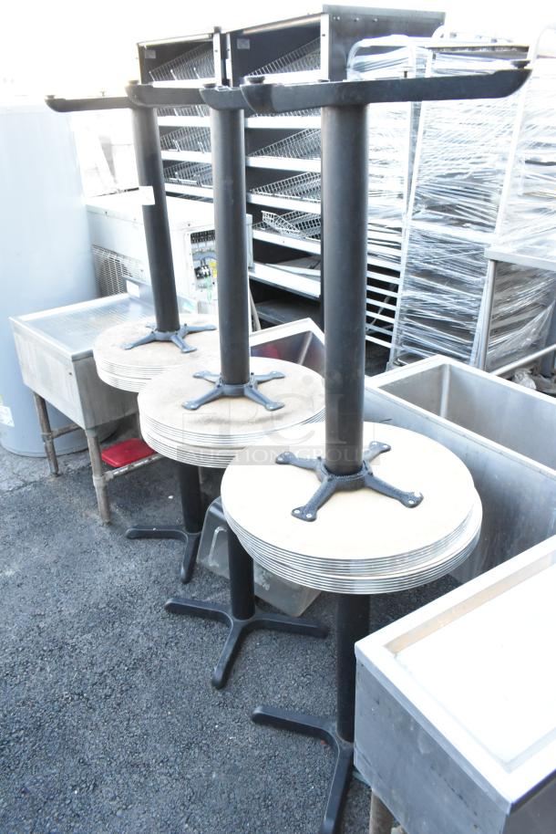 Six round tables with black metal bases stacked vertically, showing durable construction and modern design.
