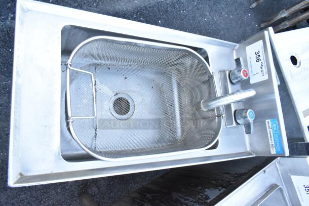 BK Resources BKUBS-1014HSS12 stainless steel sink with faucet, handles, and mesh basket. Tags show model and condition.