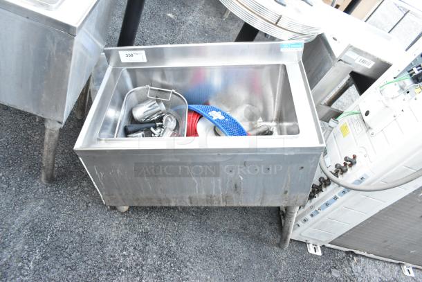 BK Resources BKIB-3012-18S stainless steel ice bin, missing left side legs, with accessories inside.
