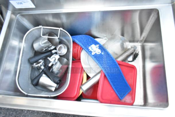 BK Resources BKIB-3012-18S stainless steel ice bin; missing left side legs, includes various utensils and accessories inside.