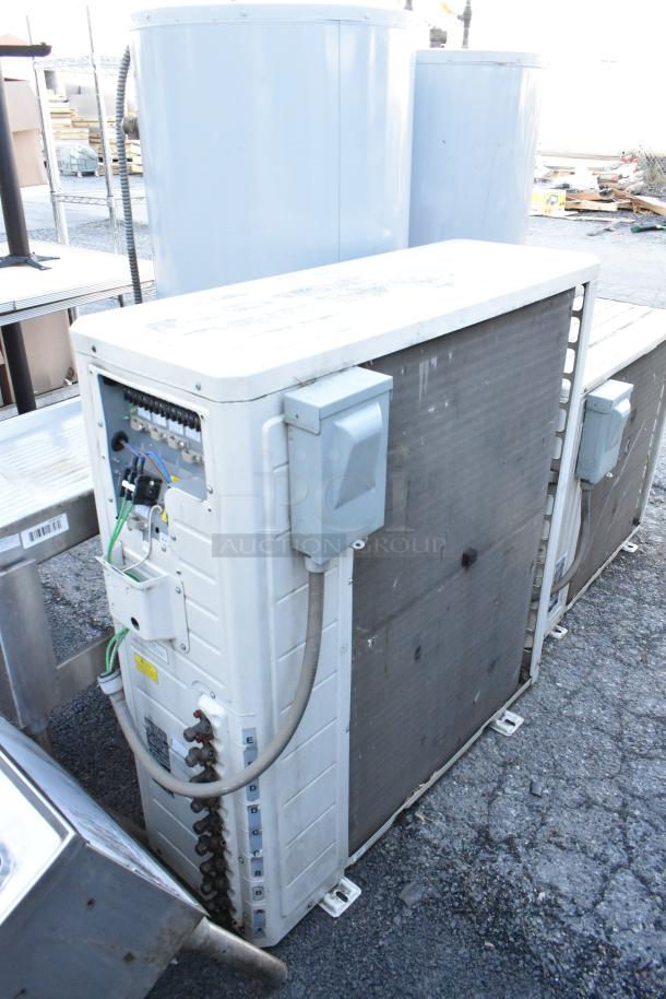 Gree metal outdoor unit for split air conditioner; visible wiring and connections; appears in used condition.