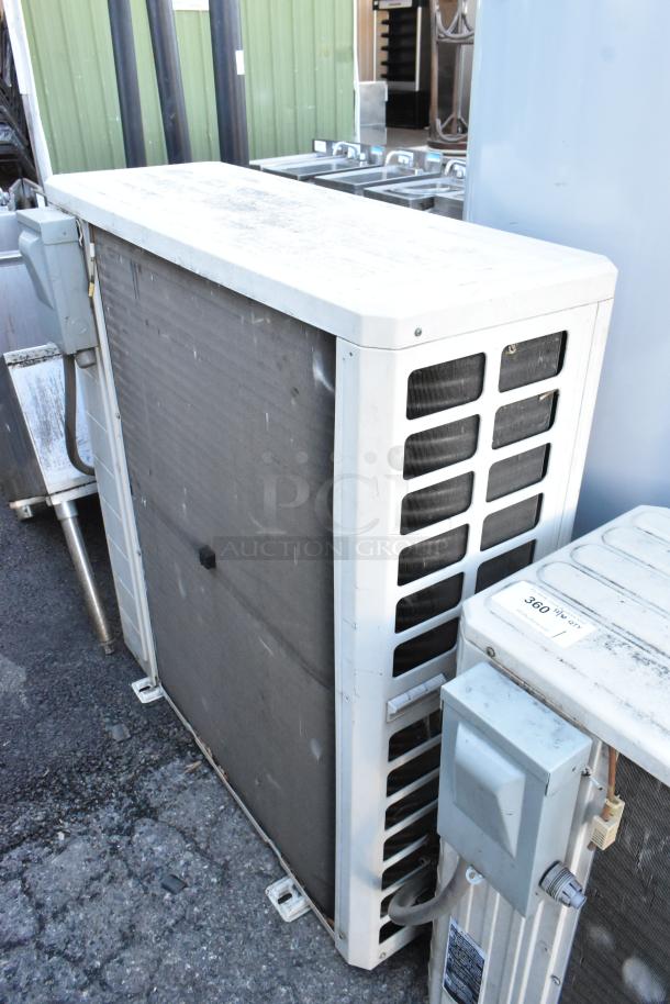 Gree metal outdoor unit for split type AC, good condition, visible wear, with power and connectivity ports.
