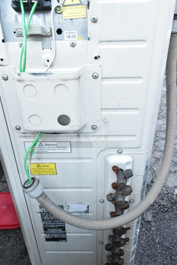 Gree metal outdoor unit for split type air conditioner, showing connection ports, warning labels, and power supply details.