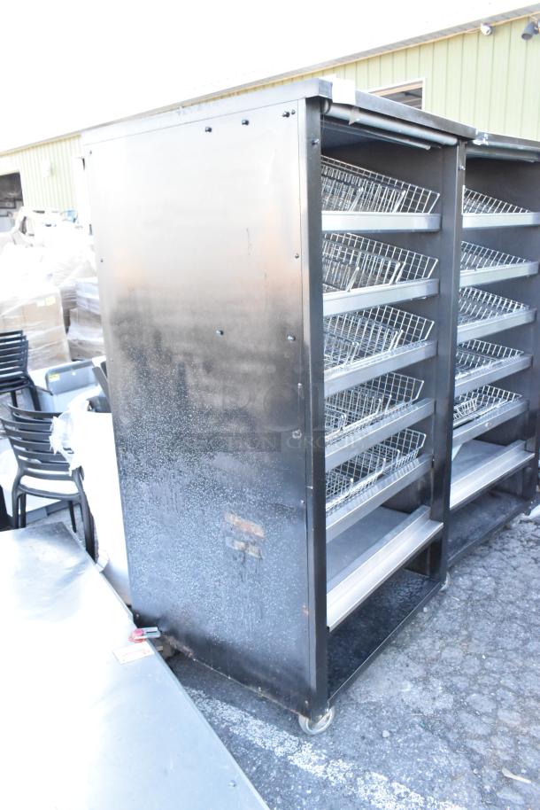 Vulcan 1013776 metal bakery display rack with shelving and commercial casters, visible wear, ideal for pastries or donuts.