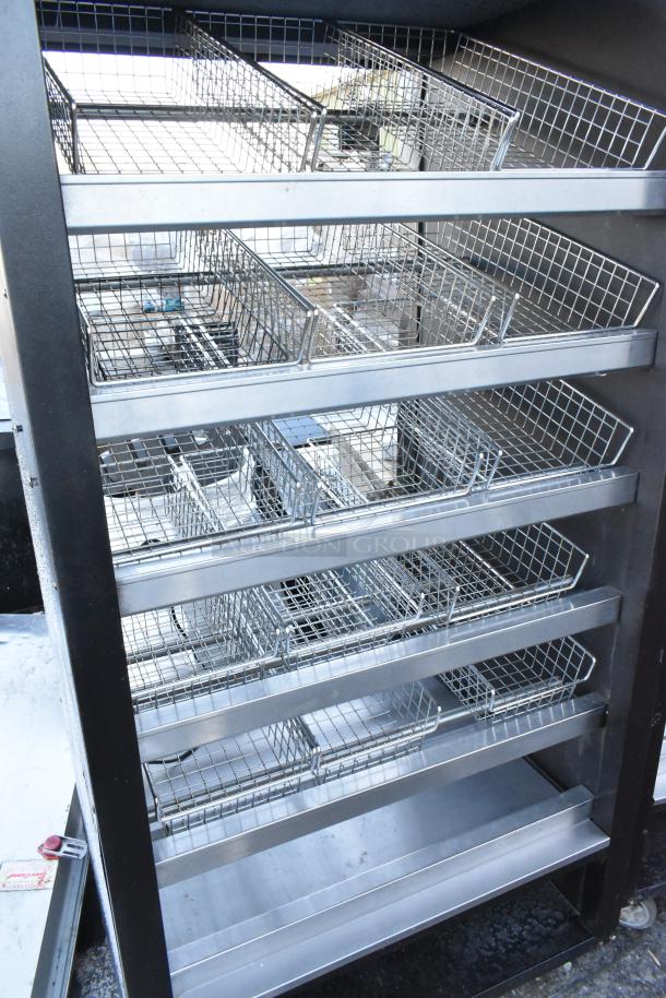 Vulcan 1013776 metal commercial bakery donut pastry display rack with multiple wire shelves on casters, in good condition.